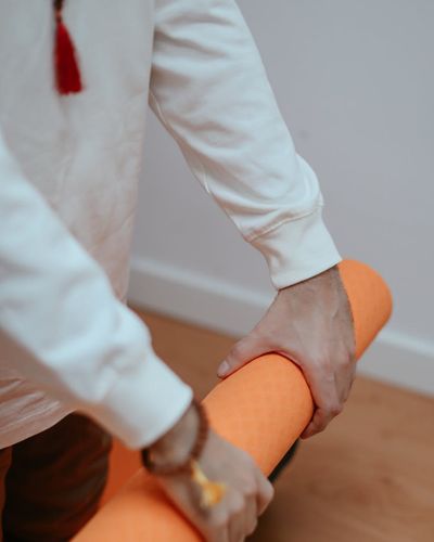 Close-up on a person's hands during a floor exercise, showing focus.